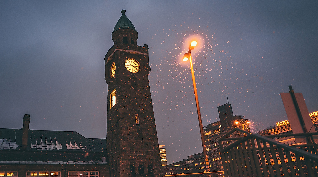 Landungsbrücken clock tower illuminated at dusk with Christmas lights and festive atmosphere