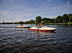 Zwei Tretboote mit Ausflüglern auf der Alster an einem sonnigen Sommertag in Hamburg
