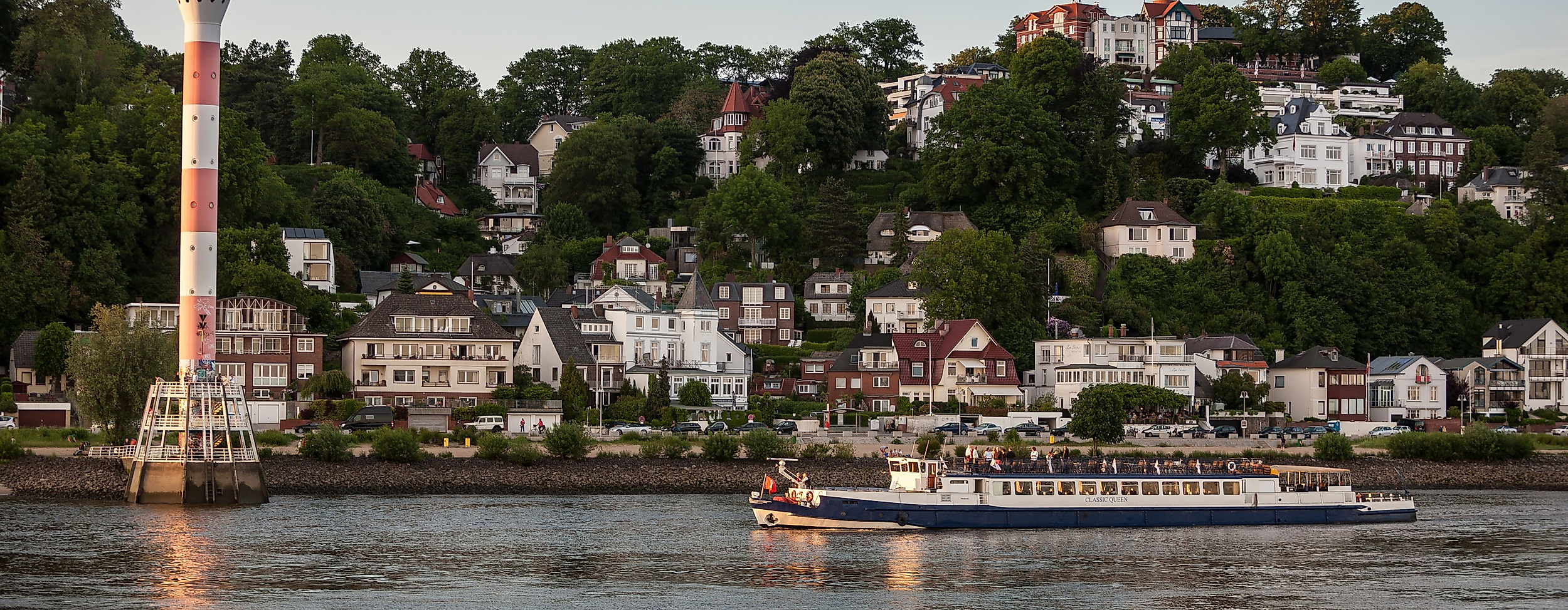 Schiff auf der Elbe vor dem Elbvorort Blankenese mit Leuchtturm und Villen am Hang